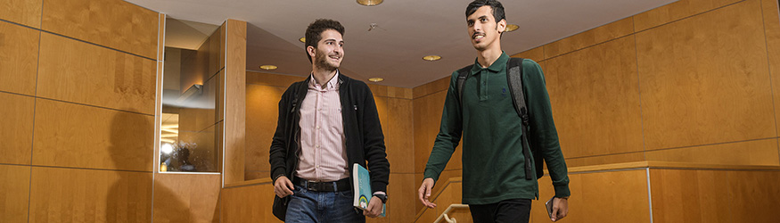 photo of two students walking in millett hall