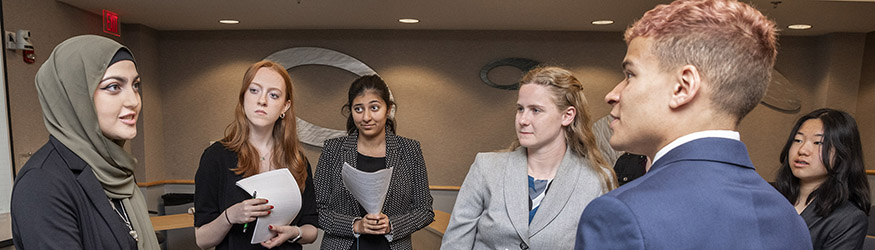 photo of high school model un students standing together and talking