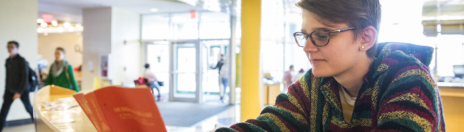 photo of a student reading a book in the student union