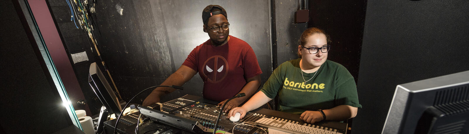 photo of two college of liberal arts students working on a theatre production