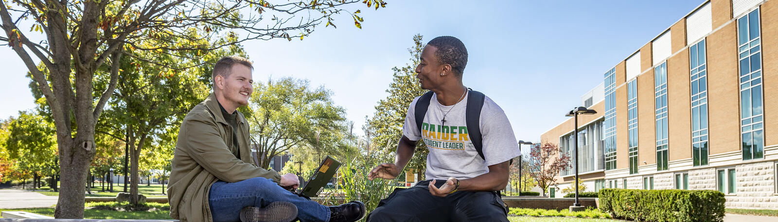 photo of students sitting outside talking on wright state's campus