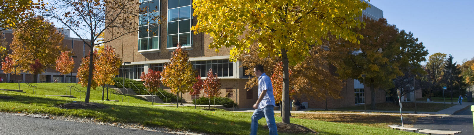 photo of a student walking outside on campus