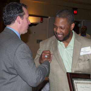 2014 Chair’s Award winner Ronnie Moreland being congratulated by 2013 COM Dept Alum Dr. Robert Leonard